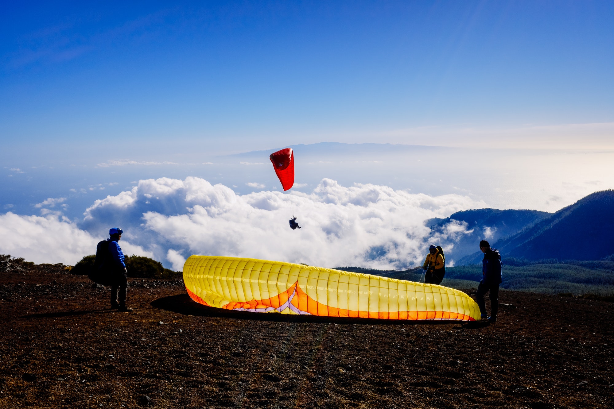 skydiving-experts-and-monitors-prepare-the-sail-of-a-paraglider-to-fly.jpg